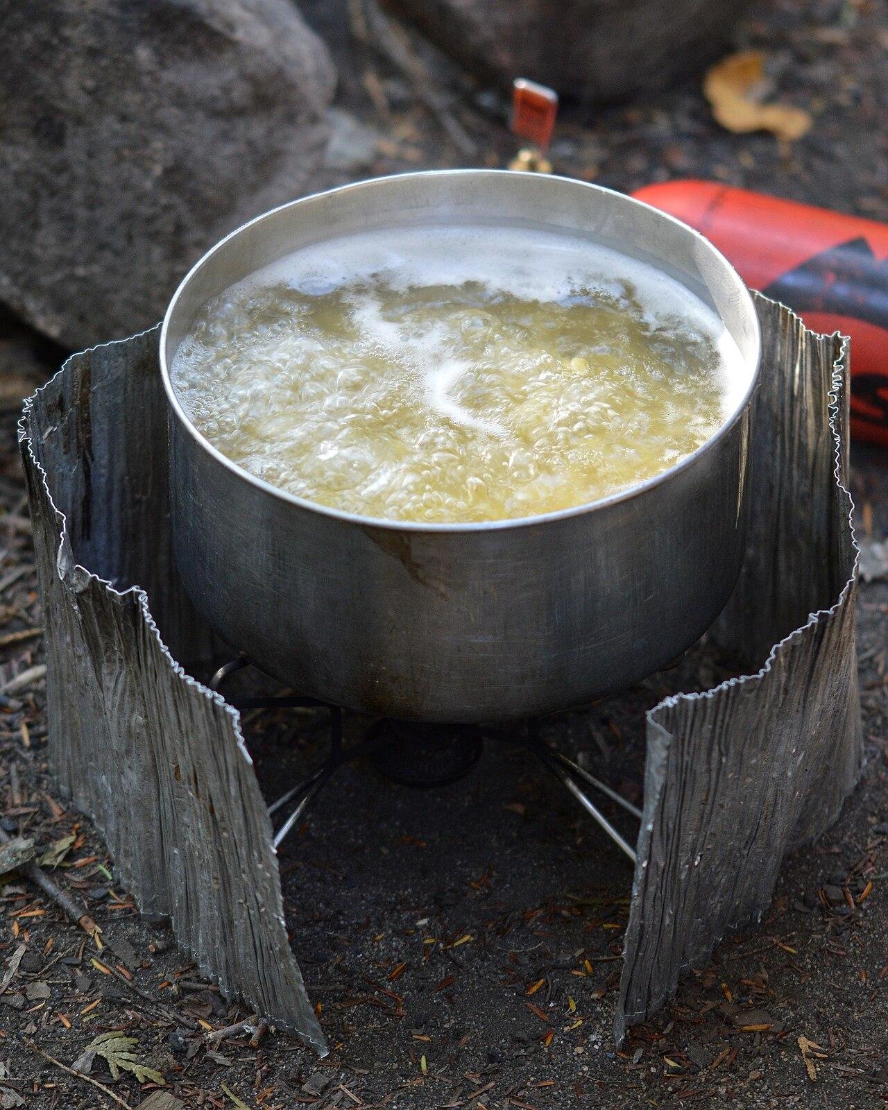 Water boiling in a pot on a camp stove